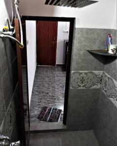a bathroom with a shower and a walk in shower at Tulsi Authentic Homestay - Beach Village Goa in Canacona