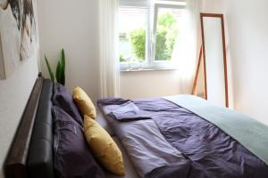 a bed sitting in a room with a window at Ferienwohnung Familie Strehl in Frickingen