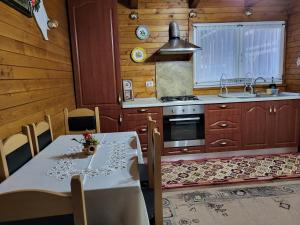 a kitchen with a table and a sink and a stove at Casa Cornelia in Borsa