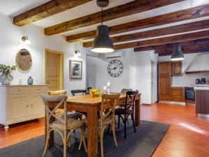 cocina y comedor con mesa de madera y sillas en Holiday Home Villa Farfalla by Interhome, en Tinjan