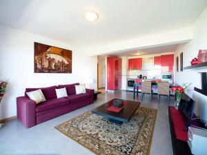 a living room with a purple couch and a table at Apartment Full moon by Interhome in Portimão
