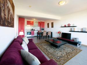 a living room with a purple couch and a table at Apartment Full moon by Interhome in Portimão