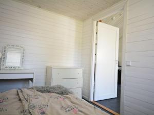 a bedroom with a bed and a mirror and a door at Apartment Åmot höjden - HAL030 by Interhome in Mellbystrand