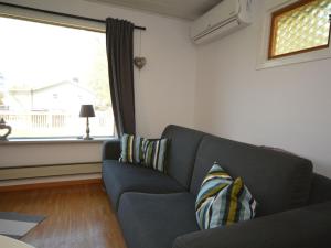 a living room with a blue couch and a window at Apartment Åmot höjden - HAL030 by Interhome in Mellbystrand