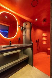 a bathroom with a sink and a mirror at ALFA HOTEL in Skaramangás