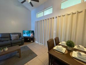 a living room with a couch and a table at Villa near Disney, Orlando in Kissimmee