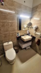 a bathroom with a toilet and a sink at Villa KAILASA in Mukteshwar