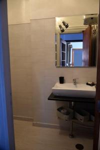 a bathroom with a sink and a mirror at Casa da Farmácia - Paredes de Coura in Paredes de Coura +15 photos