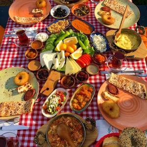 a table with many plates of food on a table at Hotel PINE BAY CLUB & Cakistes Breakfast Restaurant next to popular Kervansaray beach in Kyrenia