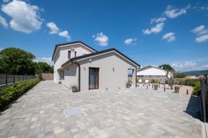 a white house with a brick driveway at Villa Monika in Krk