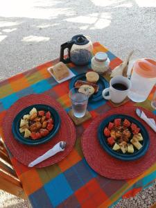 una mesa con platos de comida y café. en Cabañas Cinco Elementos, en Celestún