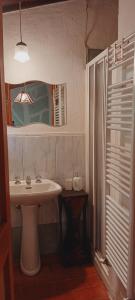 a bathroom with a sink and a mirror at All'Antico Silbule in Capolona