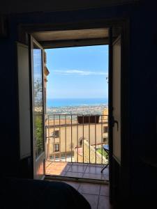 a door to a balcony with a view of a building at Experience Museum in Agrigento