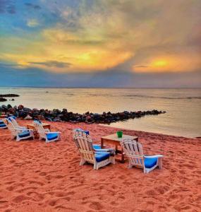 a group of chairs and tables on a beach at Ghazala Boutique Hotel Dahab in Dahab