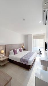 een slaapkamer met een groot bed in een kamer bij Hotel MS Pacifico Chipichape in Cali