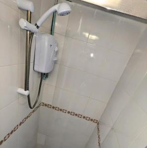 a shower in a bathroom with white tiles at No 51 - Spacious 3 Bed Home - Free Parking - Wi-Fi - Contractors in West Derby