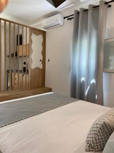 a bedroom with a bed and a wooden wall at Primos Del Mar Kalamitsi in Kalamitsi
