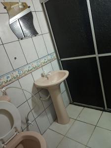 a bathroom with a toilet and a sink and a shower at NEW BUSINESS in Macapá