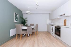 a kitchen with a table and chairs in a room at Relaxing 1BD Flat with a Roof Terrace - Portobello in Dublin