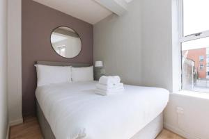 a bedroom with a white bed and a mirror at Relaxing 1BD Flat with a Roof Terrace - Portobello in Dublin