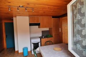 a small kitchen with a table and a stove at plain-pied proche base de loisirs et voie verte in Saulxures-sur-Moselotte +29 photos