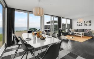 a dining room with a white table and chairs at 3 Bedroom Lovely Home In Haderslev in Kelstrup