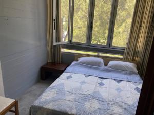 a bedroom with a bed and two windows at Punta TRE in Punta Marina +4 photos