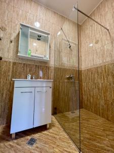 a bathroom with a shower and a sink and a mirror at Apartment Jovana in Herceg-Novi