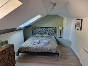 a bedroom with a bed in a attic at Bleautiful "Blanche" Charmant duplex tout confort in Fontainebleau