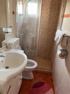 a bathroom with a toilet and a sink and a shower at Apartments Petrovic in Rogoznica +41 photos