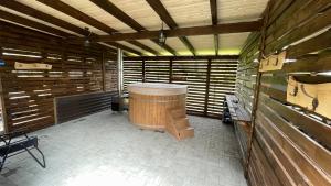 a large wooden room with a large wooden barrel at Cabana Niki-Rum Haz in Bucsin