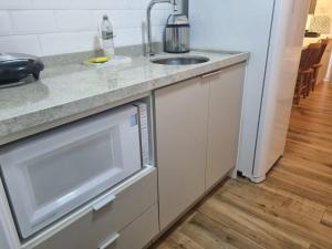 a kitchen with a sink and a dishwasher at Loft Consolação ao lado Metro, 614 in Sao Paulo