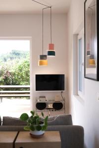 a living room with a couch and a tv at Casa Mini & Casa Mia in Aljezur