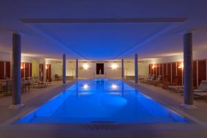 a large swimming pool in a building at night at Wellnesshotel Rothfuß mit Spa und 2 Schwimmbädern in Bad Wildbad