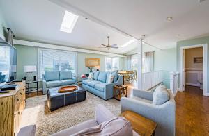 a living room with blue couches and a table at Arcadia in Duck