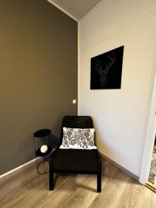 a chair in a room with a picture on the wall at Johann´s Guesthouse in Reykjavík