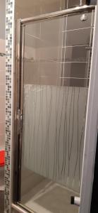 a glass door of a shower in a bathroom at Smile in Dieppe +18 photos