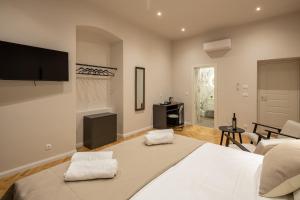 a bedroom with a large bed and a living room at Boutique LUX Rooms Odello Split Old Town in Split