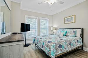 a bedroom with a bed and a flat screen tv at Windy Lane Leisure in Pawleys Island
