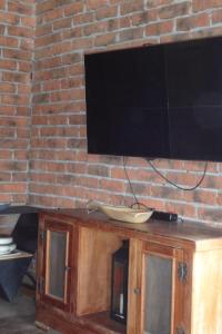 a television on top of a brick wall at Naturally Designed Secluded Villa in Kekova in Kaleucagız