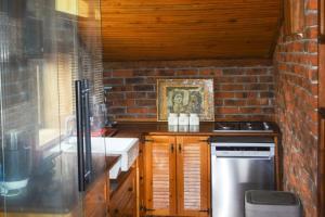 a kitchen with a stove and a brick wall at Naturally Designed Secluded Villa in Kekova in Kaleucagız