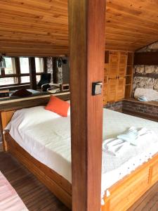 a bedroom with a bed in a wooden room at Naturally Designed Secluded Villa in Kekova in Kaleucagız