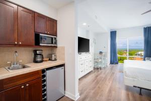 a kitchen with a sink and a bed in a room at Luau 7012 in Destin