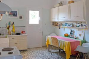 a kitchen with a table with a colorful table cloth at Sevasti Rafina in Rafina