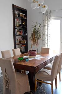 a dining room table with chairs and a plant on it at Sevasti Rafina in Rafina