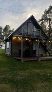 a house with a deck with lights on it at Selena 2003 in Kaunata