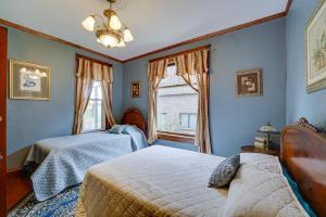 a bedroom with two beds and a window at Downtown Victorian Home Near Lake Michigan Beach! in Manistee