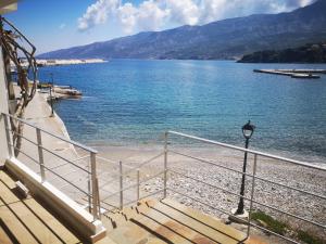 a view of a body of water with a white railing at House of light in Évdhilos