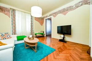a living room with a couch and a tv at '2R' City Center Holidays and Workstays in Rijeka