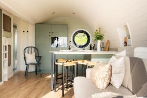 a kitchen and living room with a couch and a table at Creuddyn in Aberystwyth